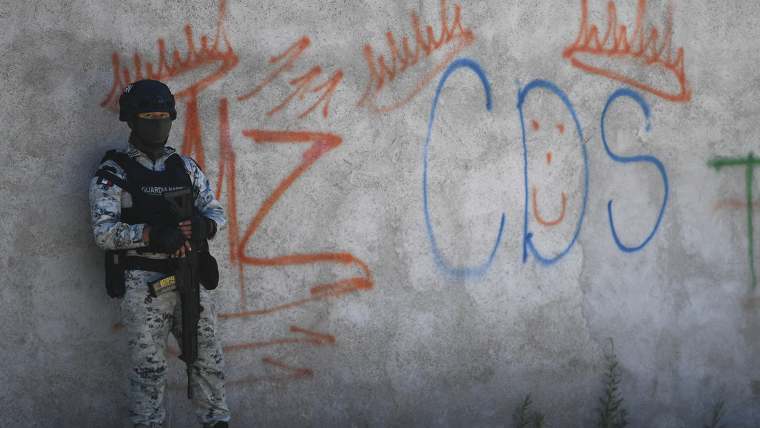 Un soldado mexicano hace guardia junto a grafitis en alusión al Mayo Zambada y el Cártel de Sinaloa, en Zacatecas. (Foto: Pedro Pardo / AFP)